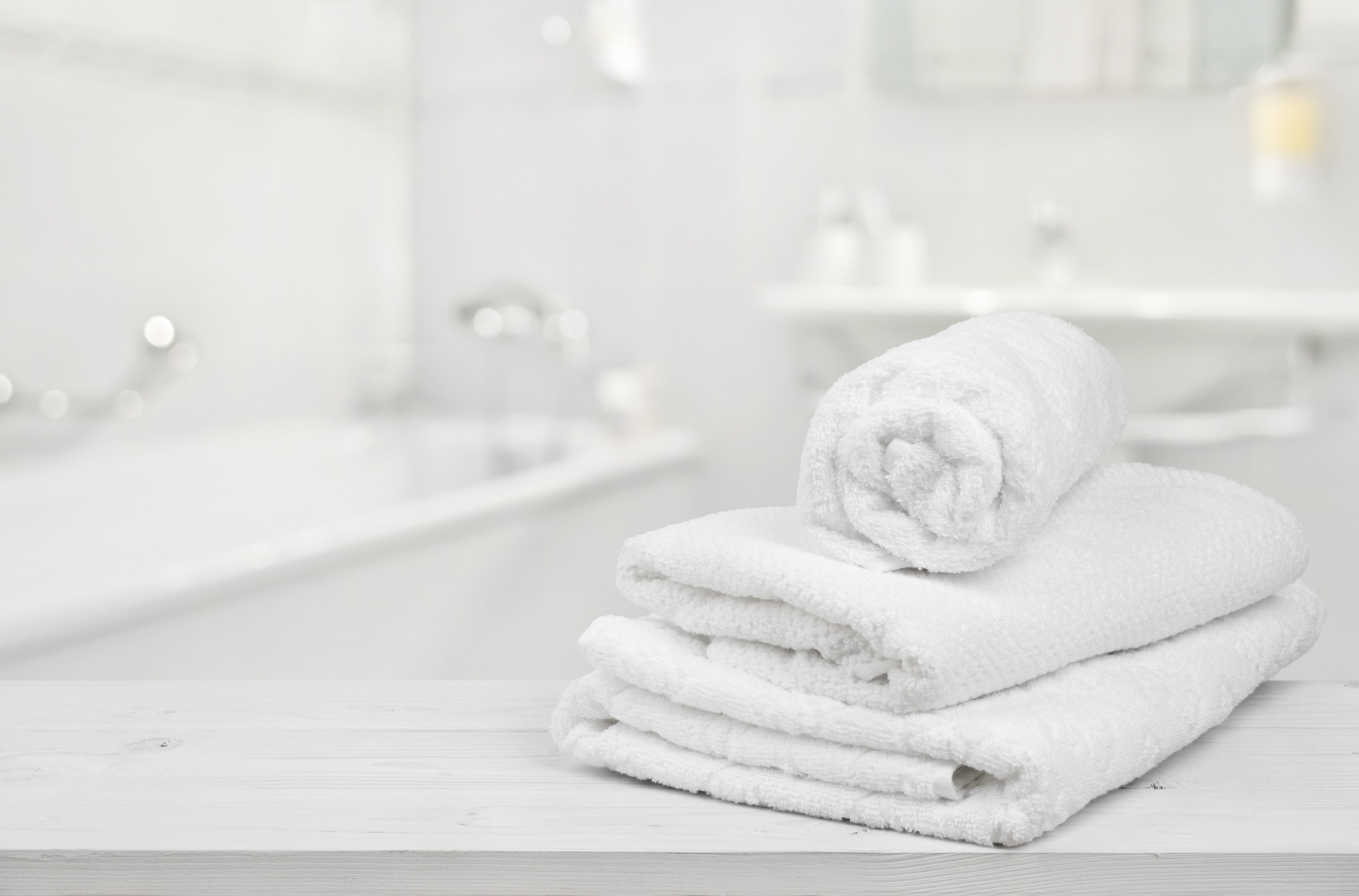 Download Stack Of Folded White Spa Towels Over Blurred Bathroom Background Innovative Tub Solutions