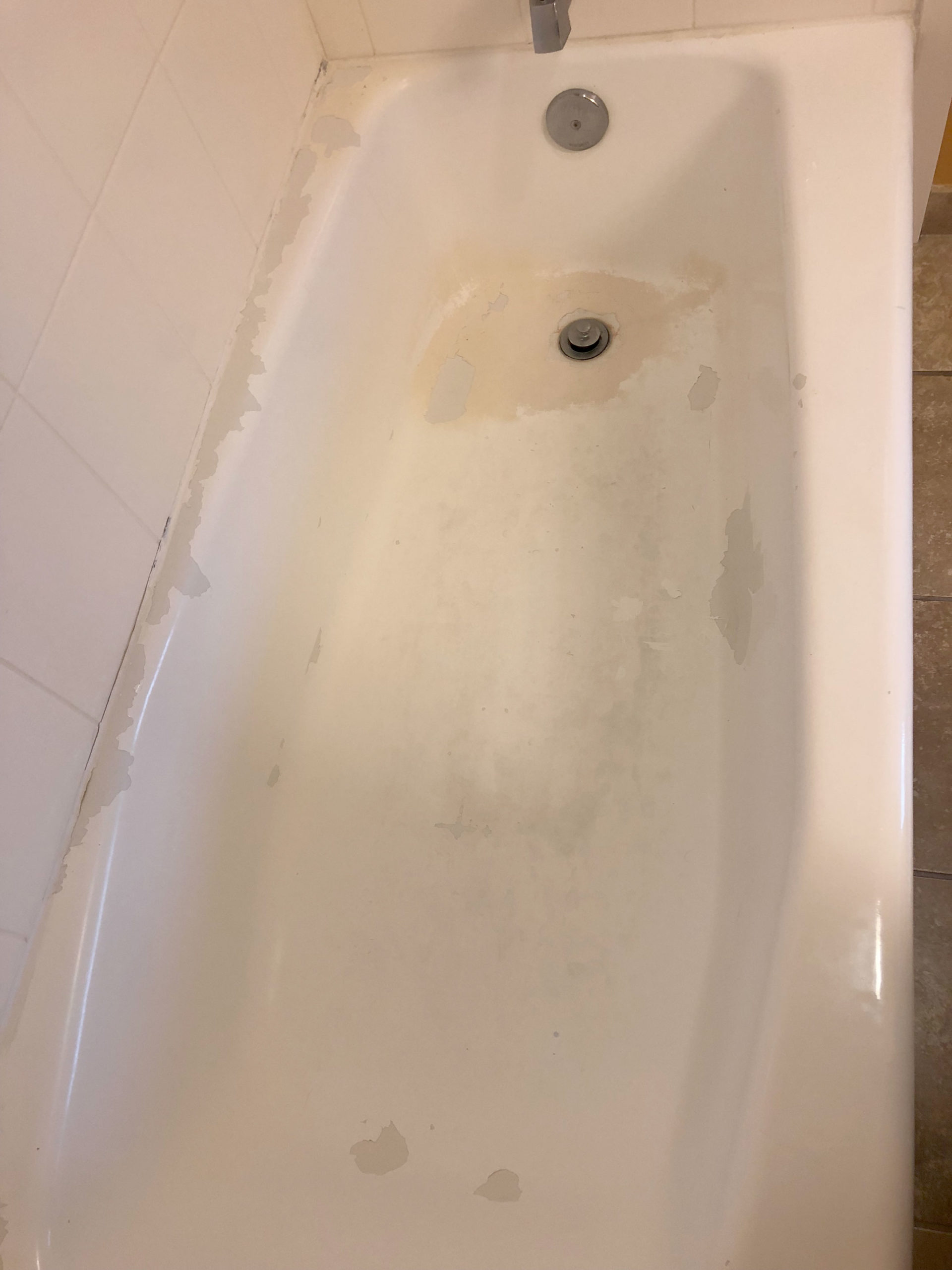 Chipped and peeling tub before